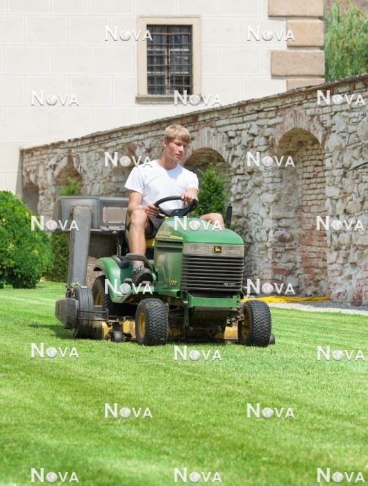 N2102192 Gardener mowing the lawn