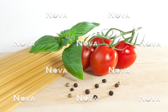 N2100700 Tomatoes, basil and spaghetti on cutting board